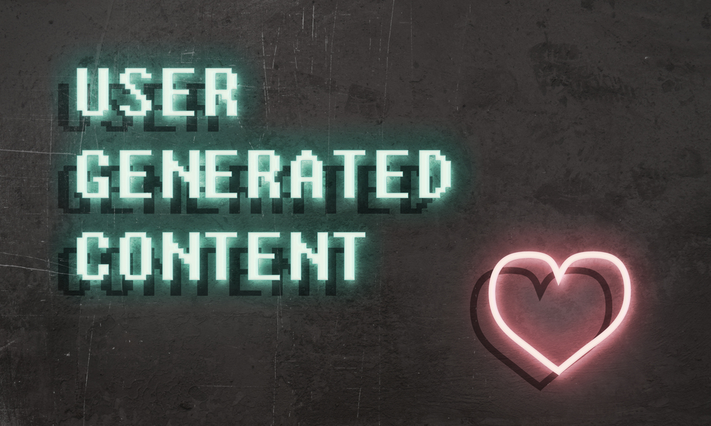 The image shows the words "USER GENERATED CONTENT" in glowing green pixelated font on a textured dark background, alongside a neon pink heart shape.